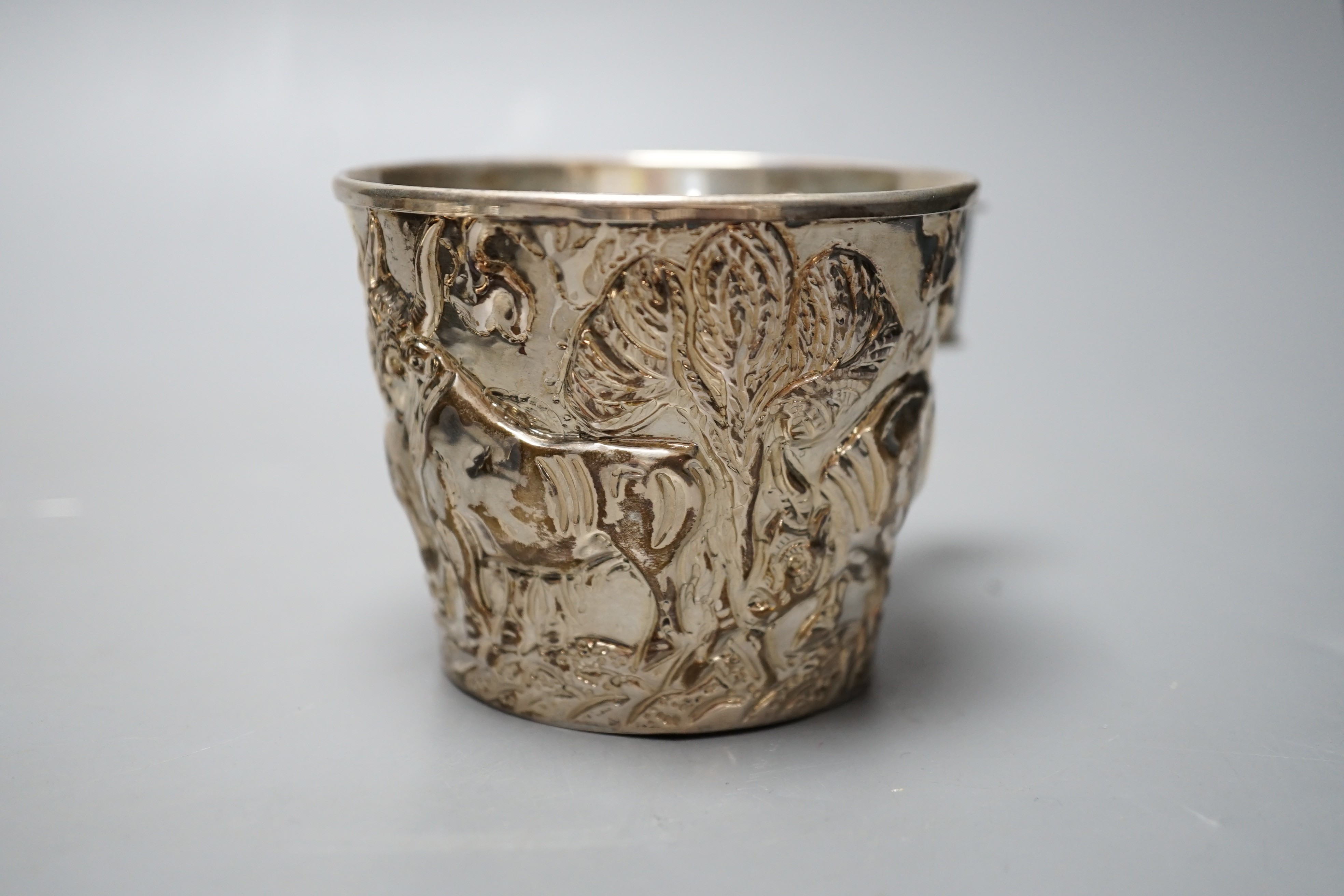 A Greek 900 standard white metal cup, embosses with cattle, height 66mm and a similar dish, gross 10.2oz.